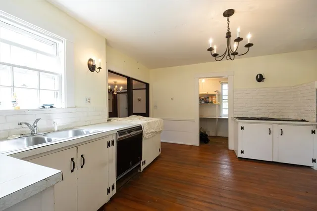 a kitchen with a sink stove and cabinets