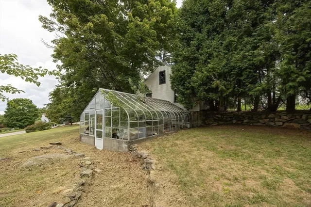 a view of a house with backyard sitting area and garden