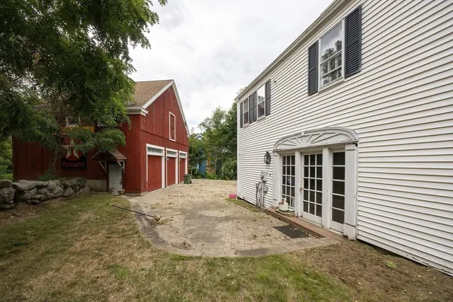 a view of a house with a patio and wooden fence