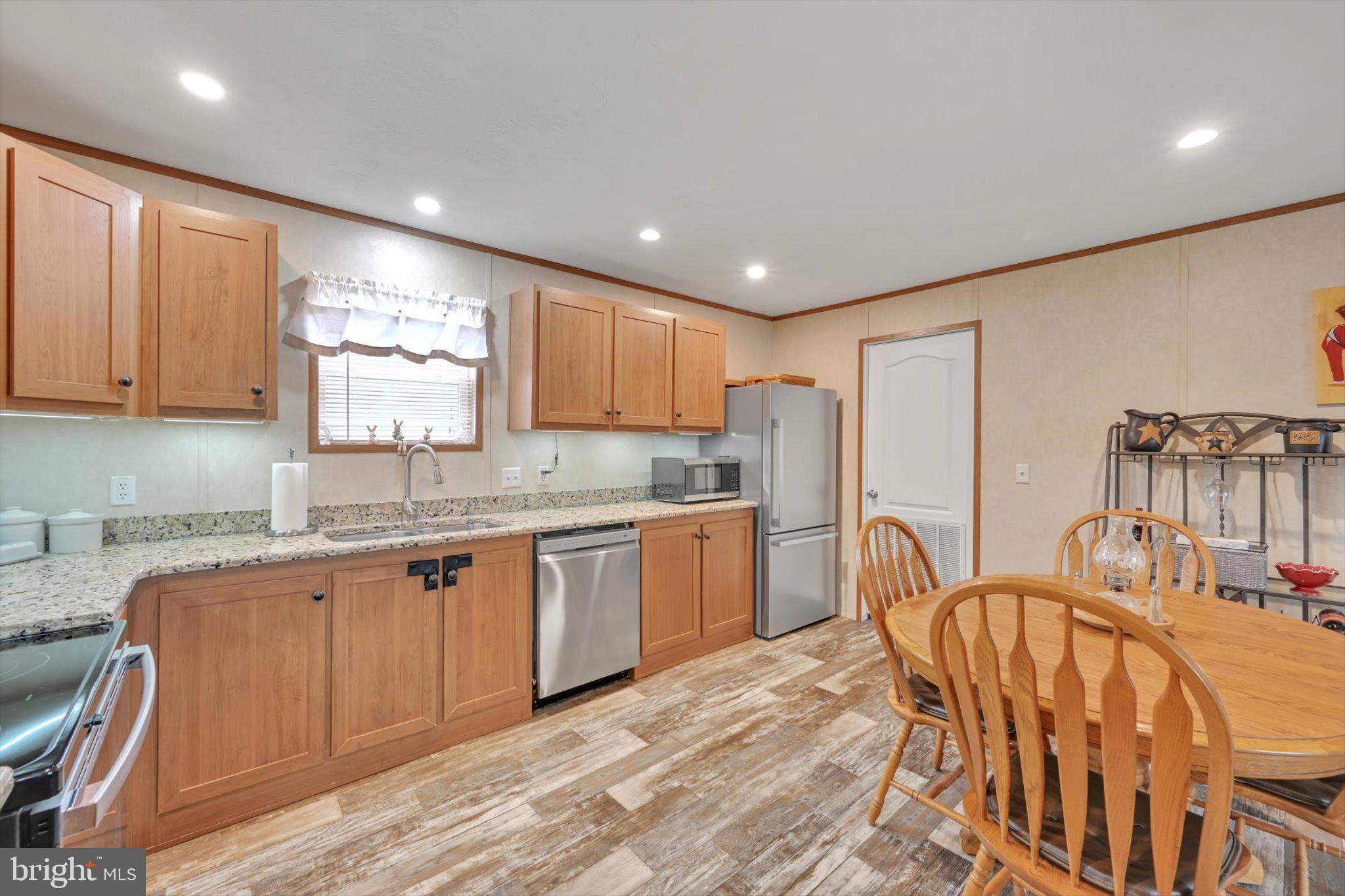 185 Weidler Lane Lititz, PA 17543 - Photo 6 of 25 a kitchen with granite countertop a sink stove top oven and refrigerator