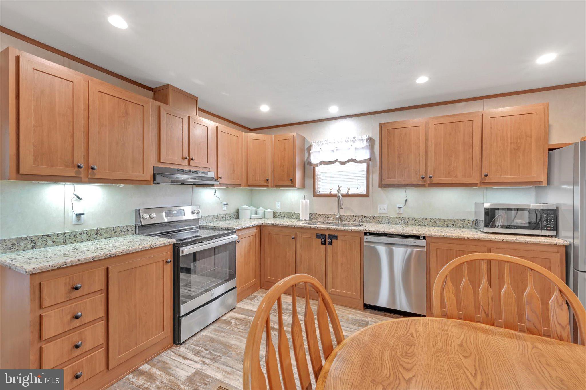 185 Weidler Lane Lititz, PA 17543 - Photo 7 of 25 a kitchen with granite countertop a sink stainless steel appliances and cabinets