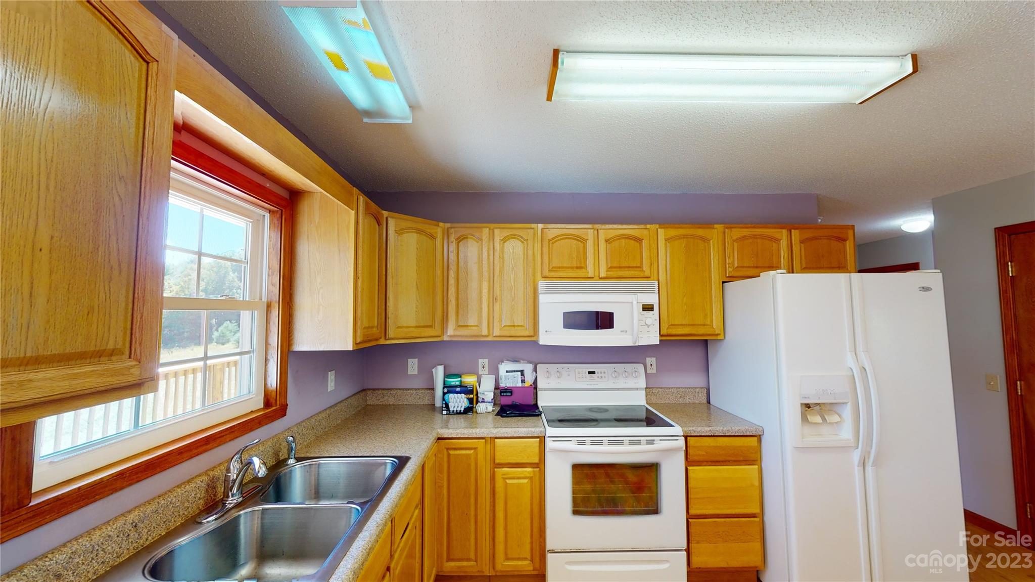 348 Becky Mountain Road Brevard, NC 28712 - Photo 4 of 26 a kitchen with a refrigerator a stove and a sink