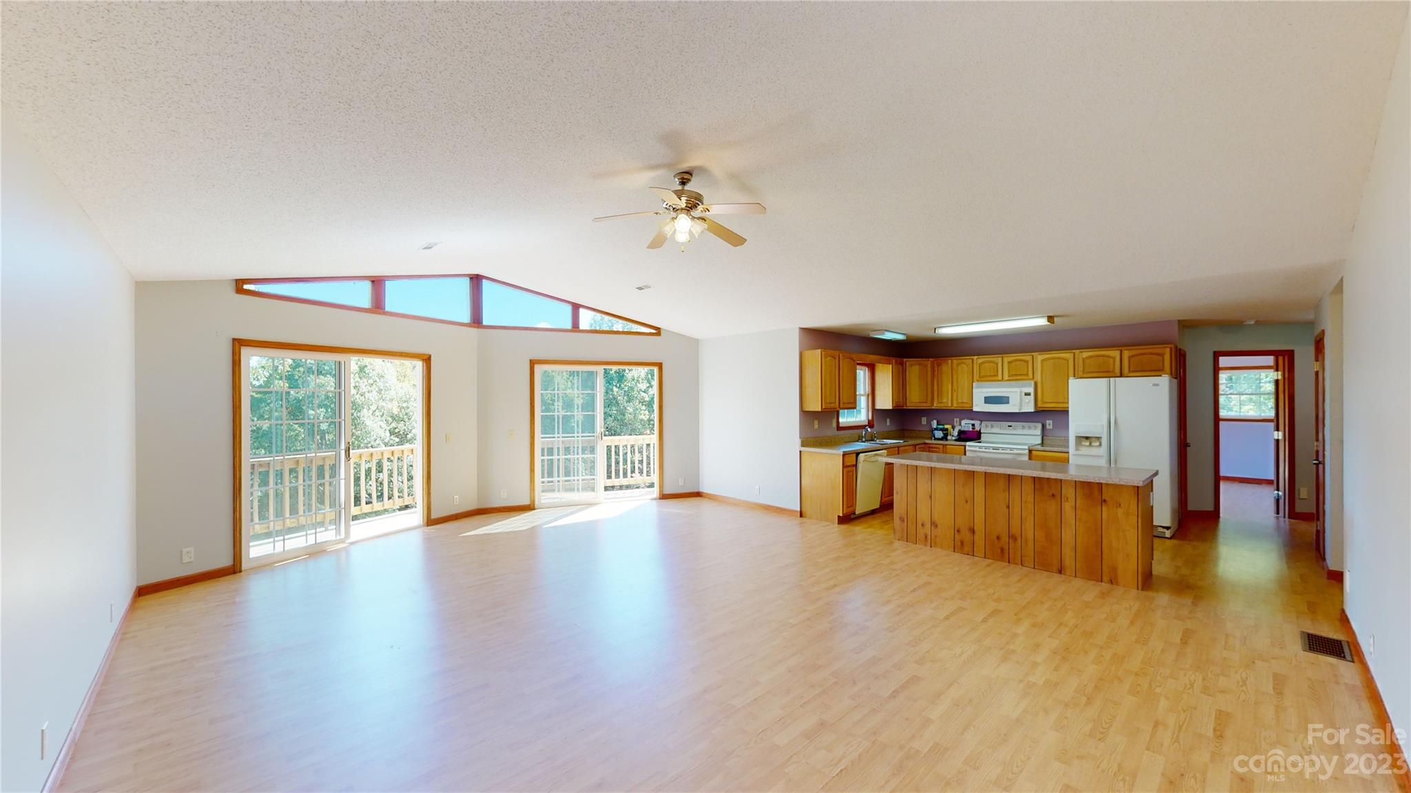 348 Becky Mountain Road Brevard, NC 28712 - Photo 6 of 26 a view of a living room with kitchen view and a large window