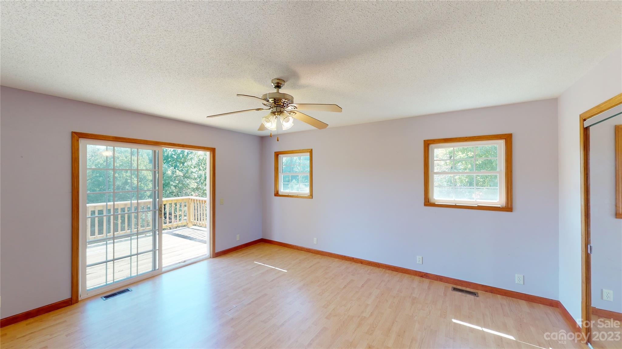 348 Becky Mountain Road Brevard, NC 28712 - Photo 9 of 26 a view of an empty room with wooden floor and a window