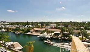 an aerial view of a city with lots of residential buildings lake and ocean view
