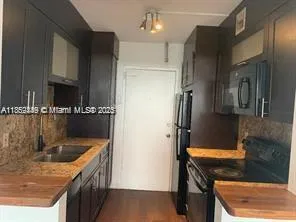 a kitchen with a sink a stove and refrigerator