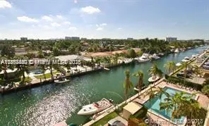 an aerial view of residential houses with outdoor space and lake view