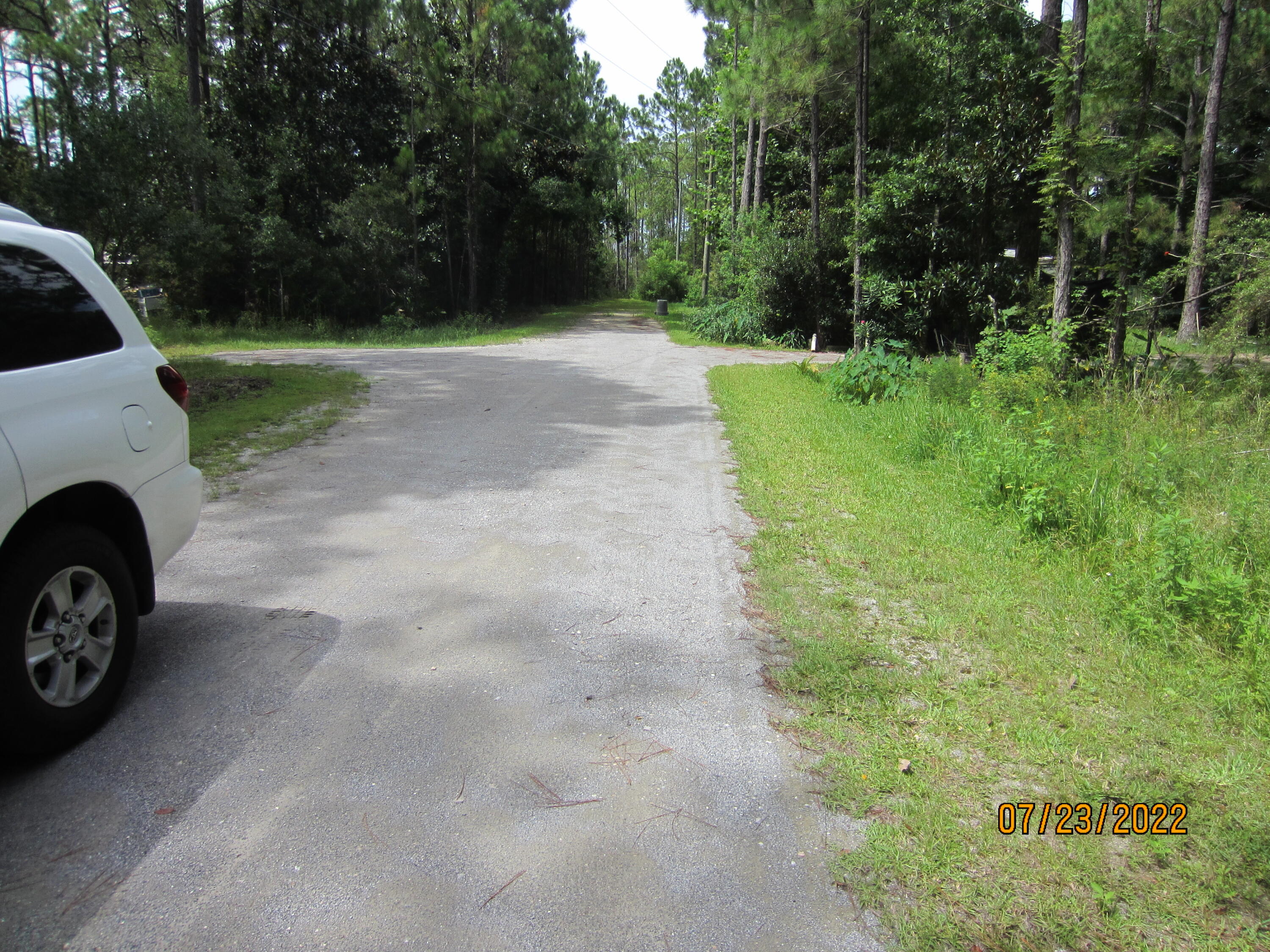a view of yard with small car parked
