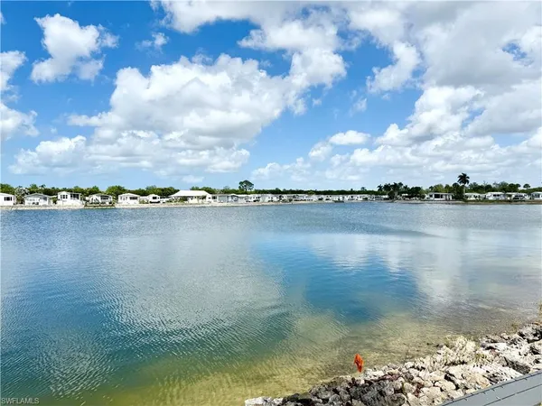 a view of a lake with houses in the back