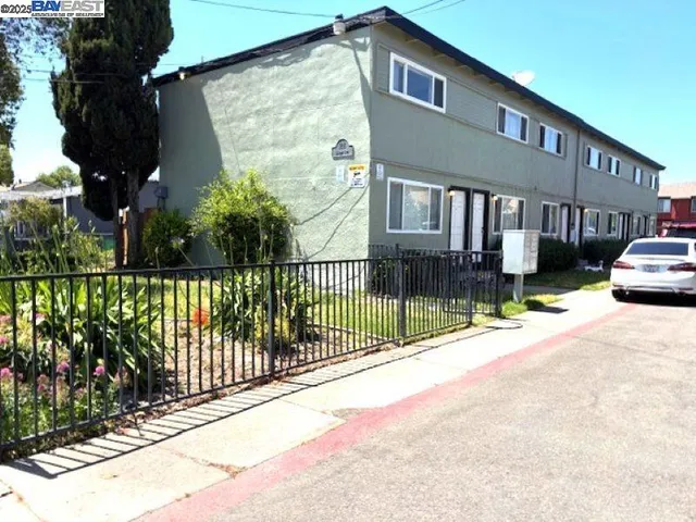 a view of a house with a wooden fence