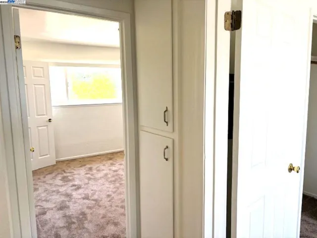 a view of a bathroom with a door and a window