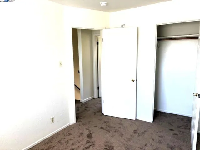 a view of a room with a refrigerator