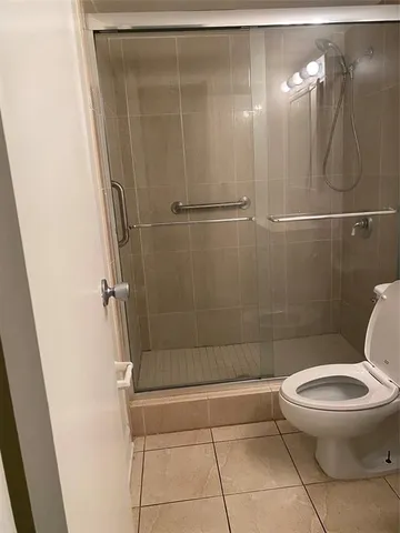 a bathroom with a toilet and a shower