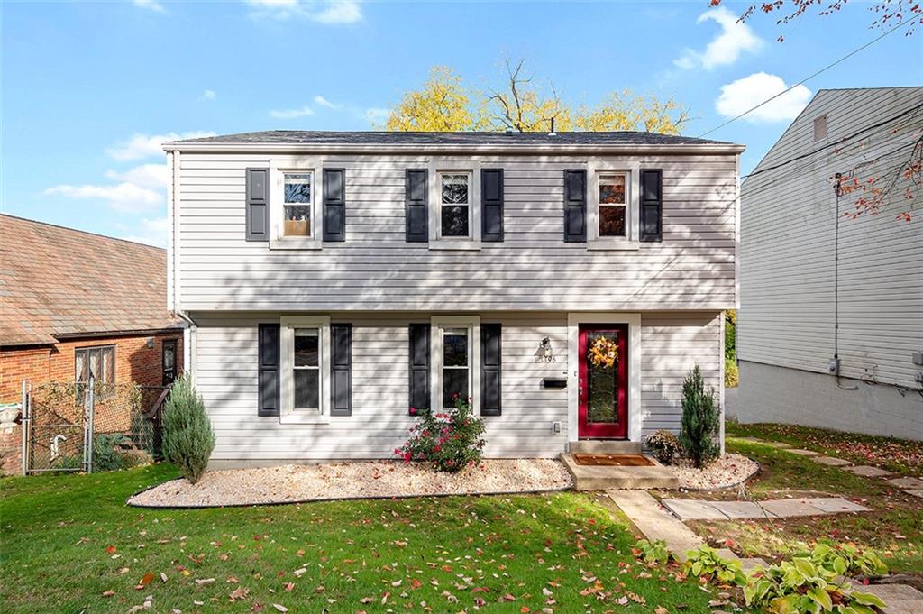 a front view of a house with a yard
