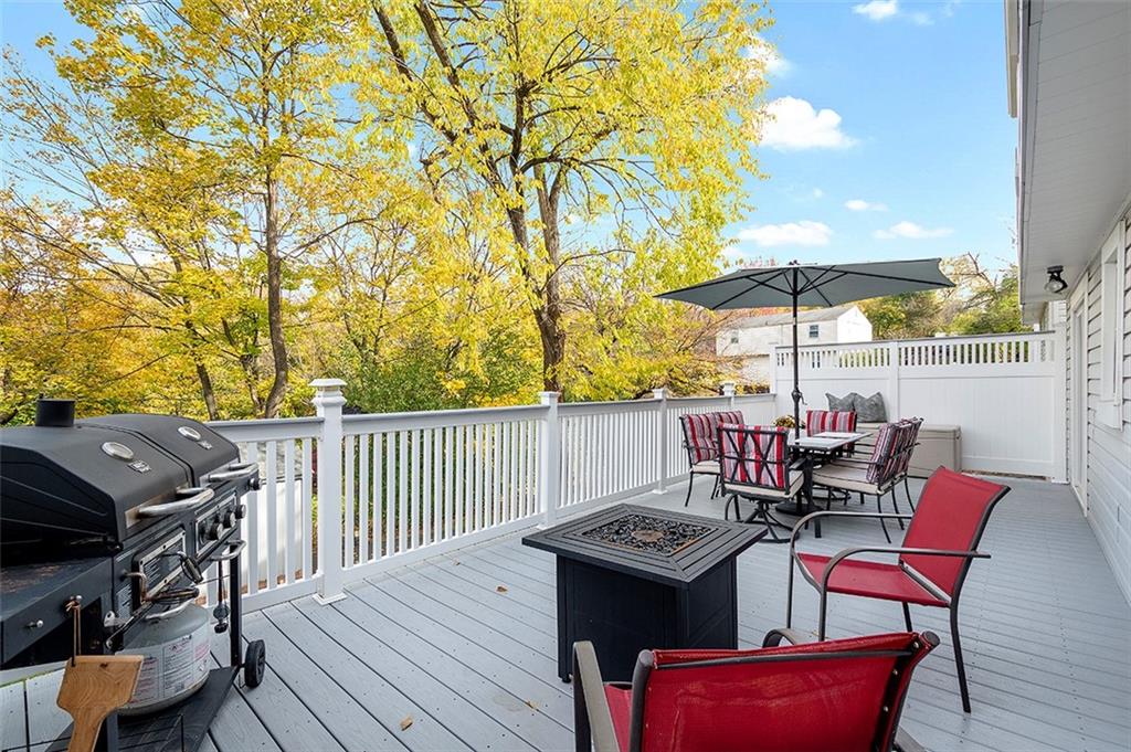 196 Cochran Road Pittsburgh, PA 15228 - Photo 12 of 25 an outdoor sitting area with furniture and umbrella