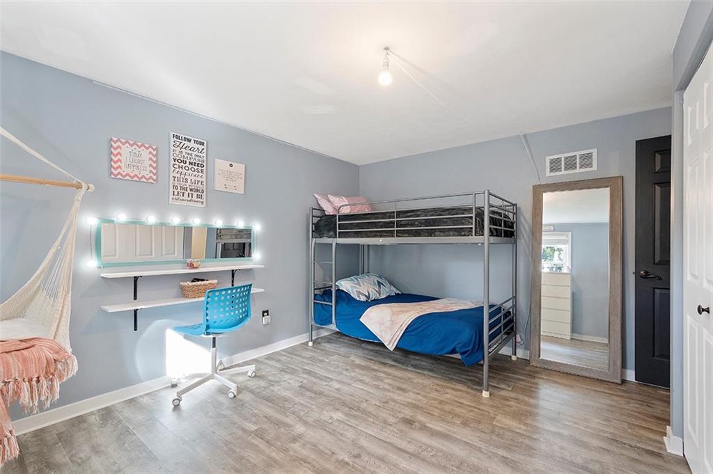 196 Cochran Road Pittsburgh, PA 15228 - Photo 19 of 25 a bedroom with a bed and a wooden floor