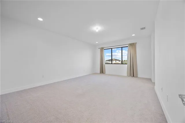 a view of an empty room and a window