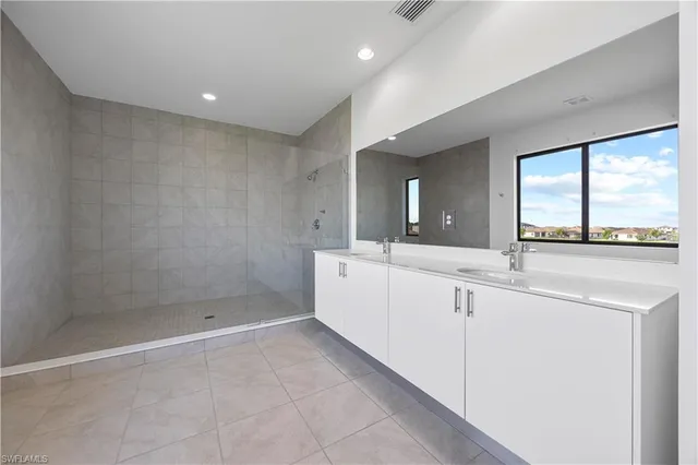 a bathroom with a sink a large mirror and a bathtub