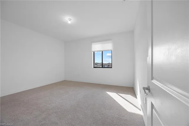 a view of a big room with wooden floor and a corridor