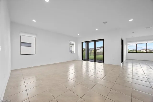 a view of an empty room with glass door