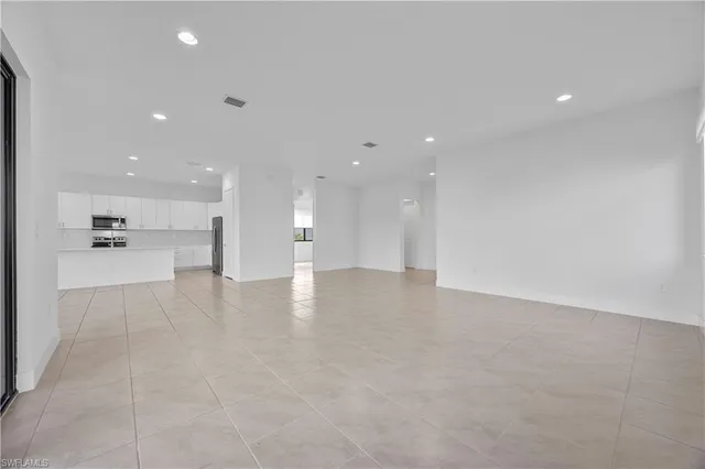 a view of a kitchen with a sink and a refrigerator