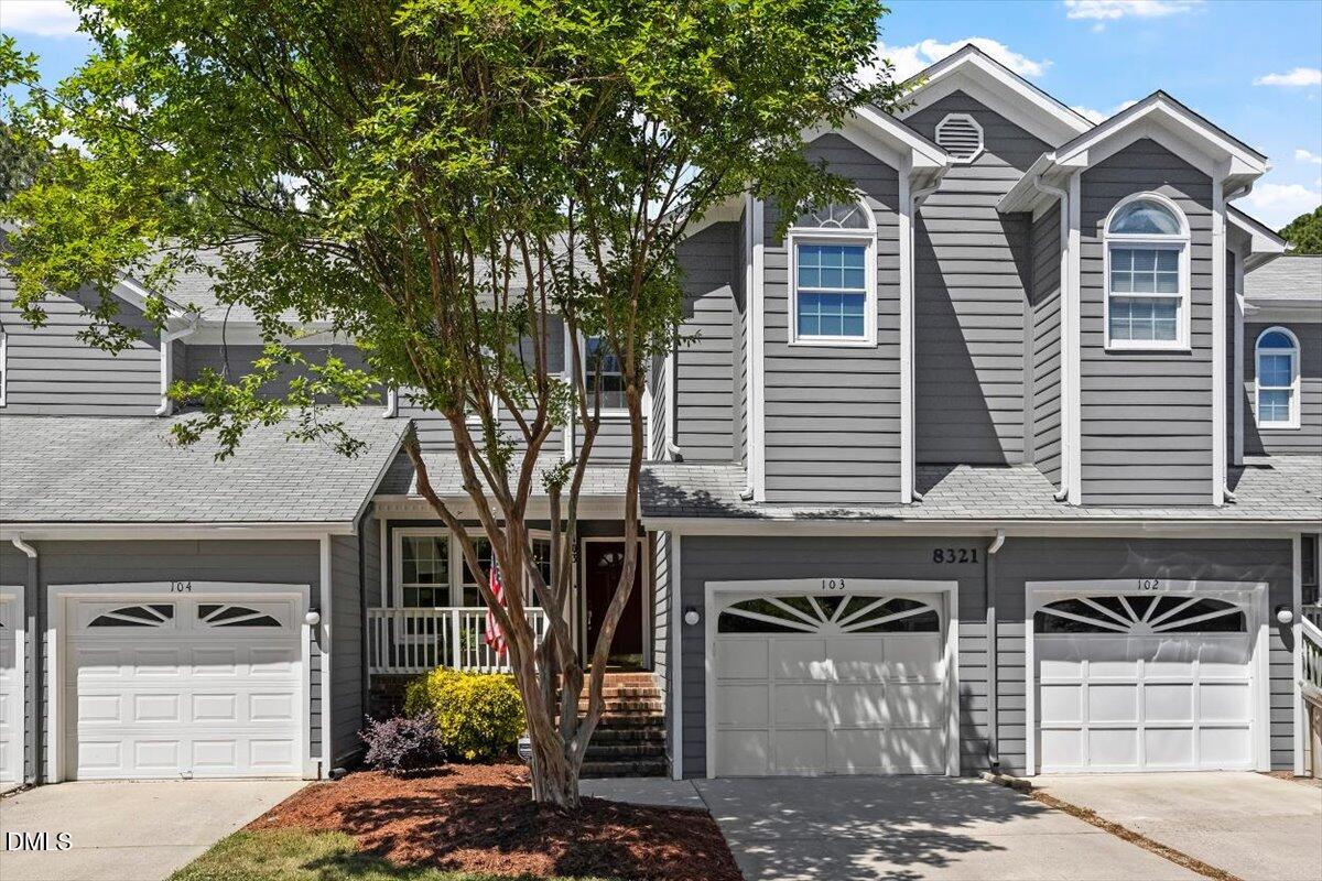 8321 Hempshire Place, Unit 103 Raleigh, NC 27613 - Photo 2 of 25 a front view of a house with garden