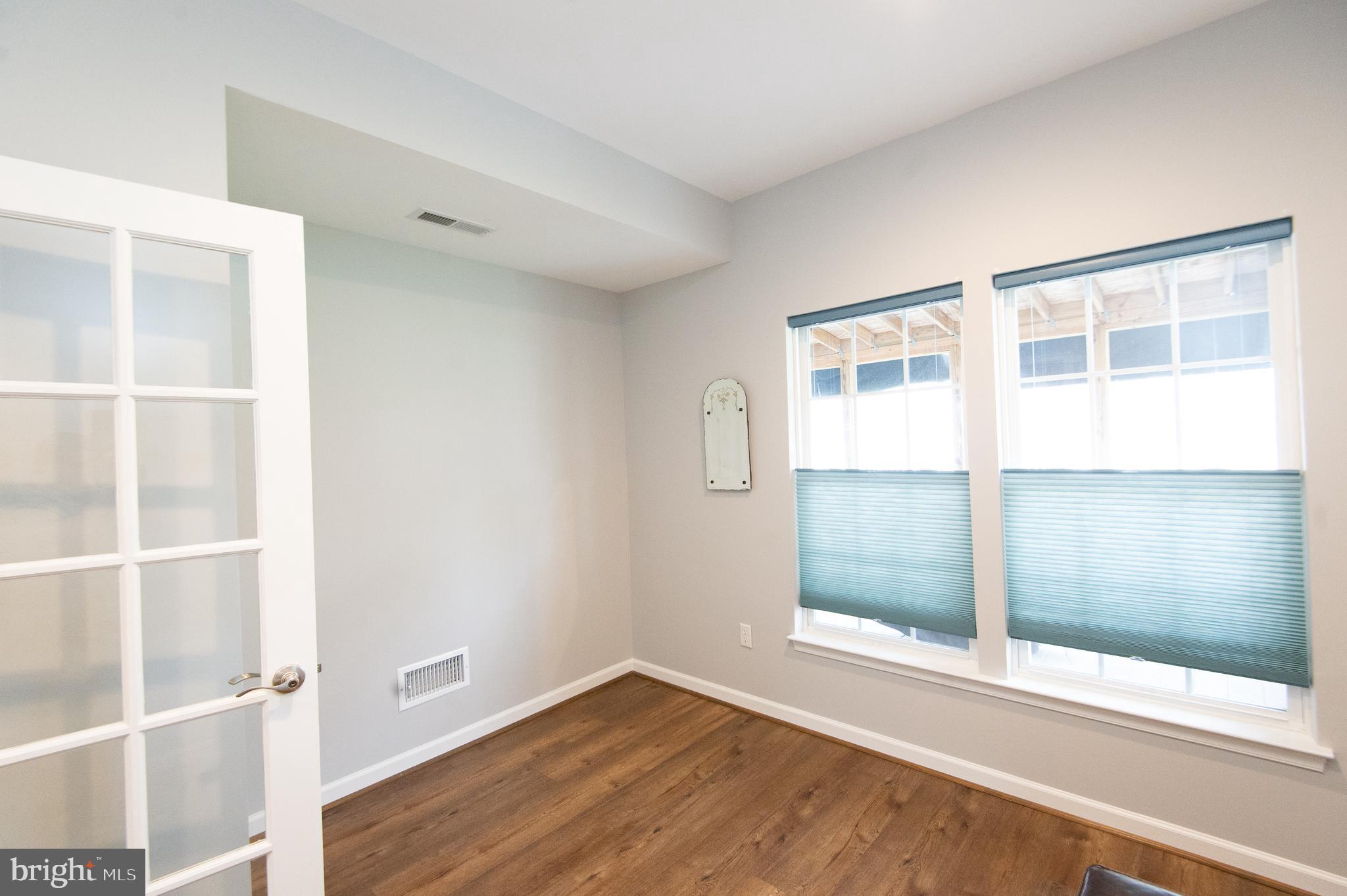 47 Brighton Street Ocean View, DE 19970 - Photo 18 of 44 an empty room with wooden floor and windows