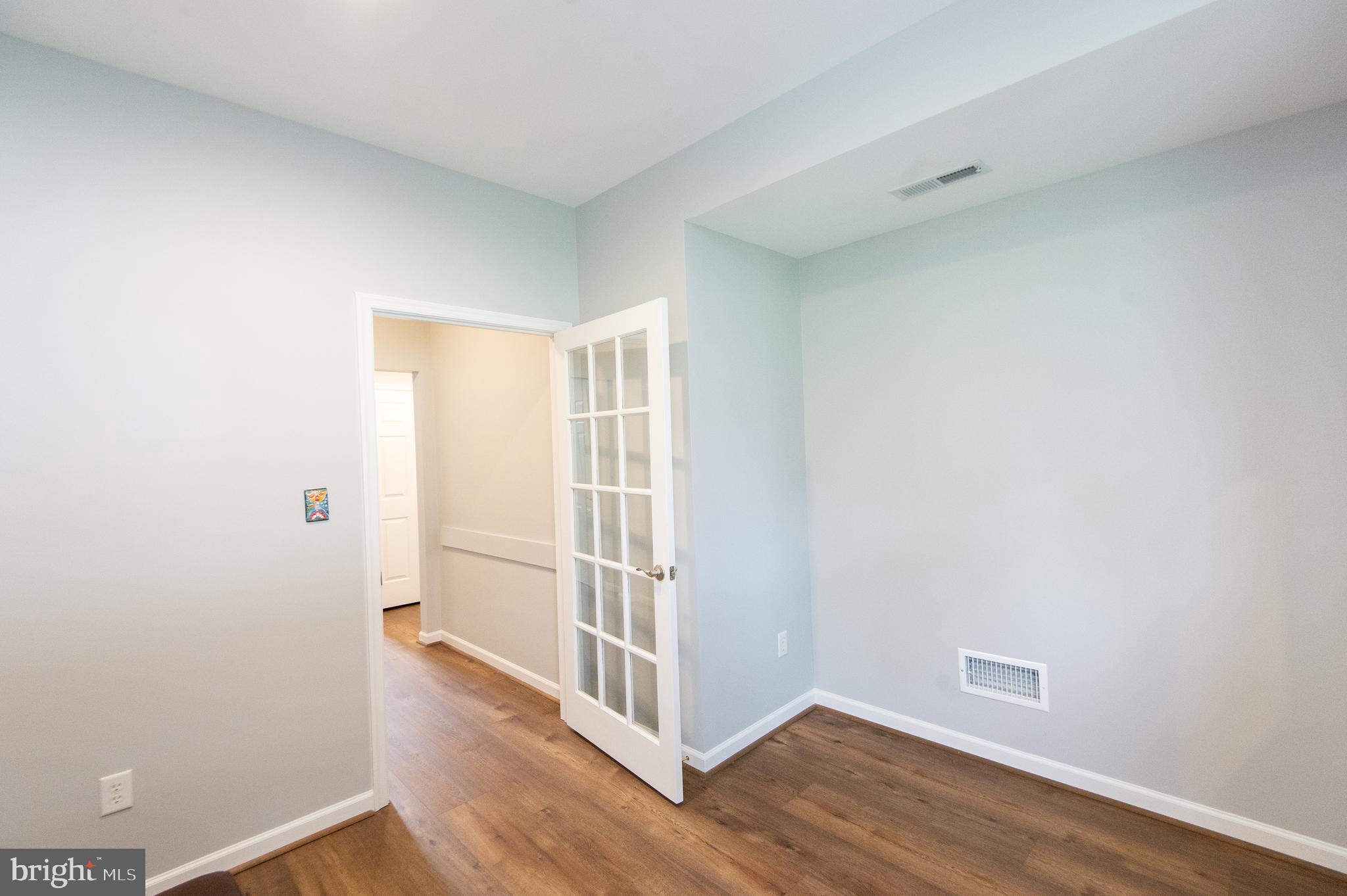 47 Brighton Street Ocean View, DE 19970 - Photo 19 of 44 a view of an empty room with wooden floor and a window