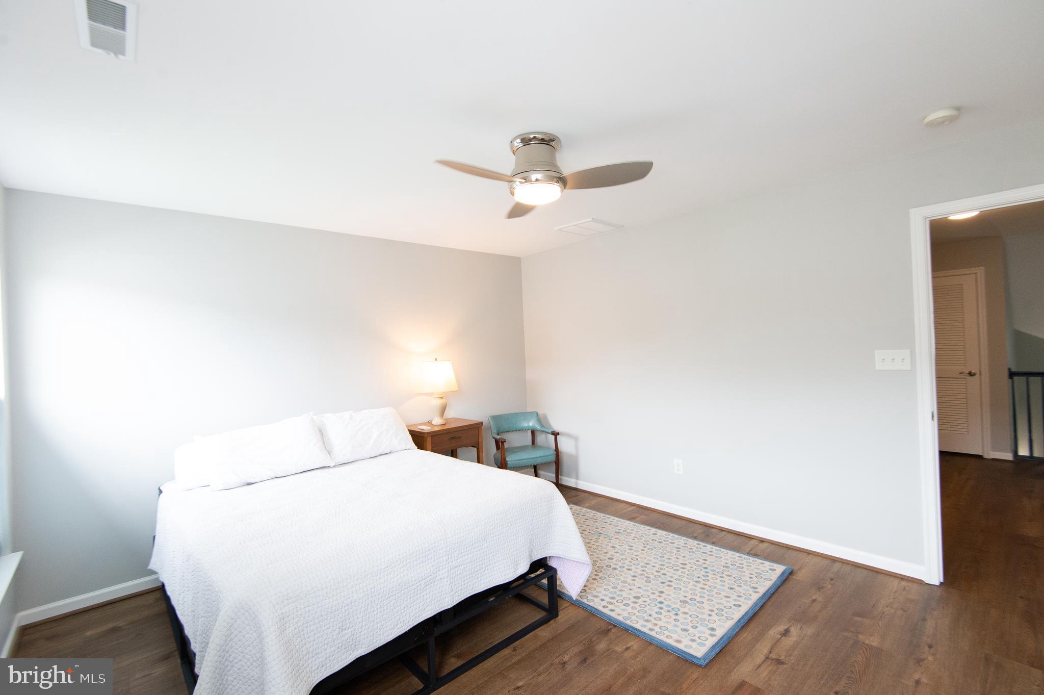 47 Brighton Street Ocean View, DE 19970 - Photo 29 of 44 a bedroom with a bed and wooden floor