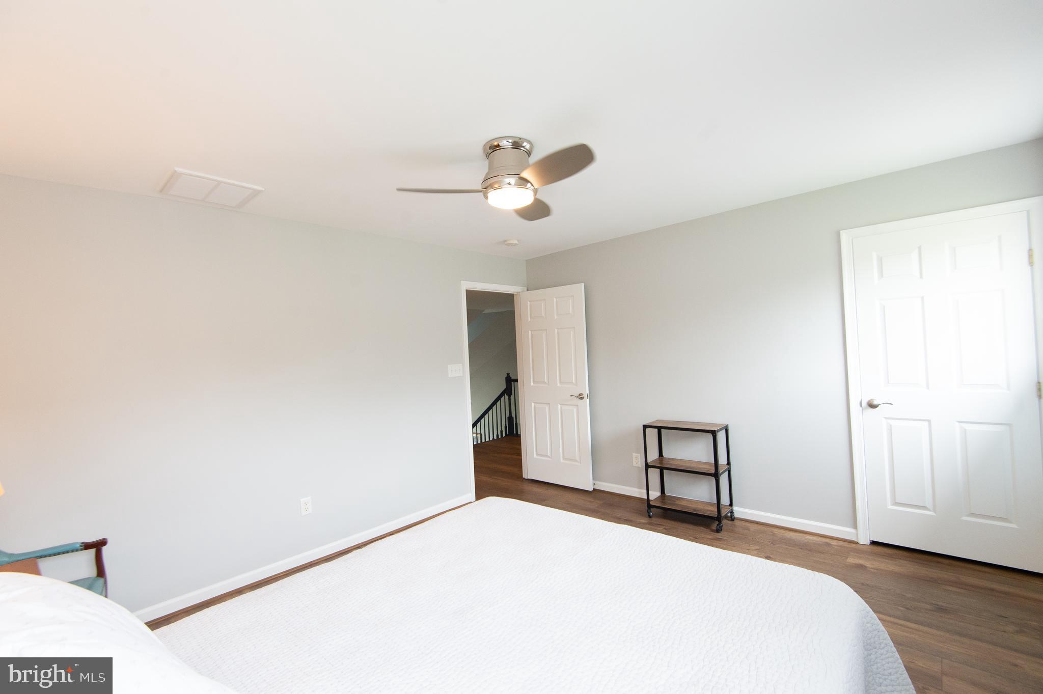 47 Brighton Street Ocean View, DE 19970 - Photo 30 of 44 a bedroom with a bed and a chandelier