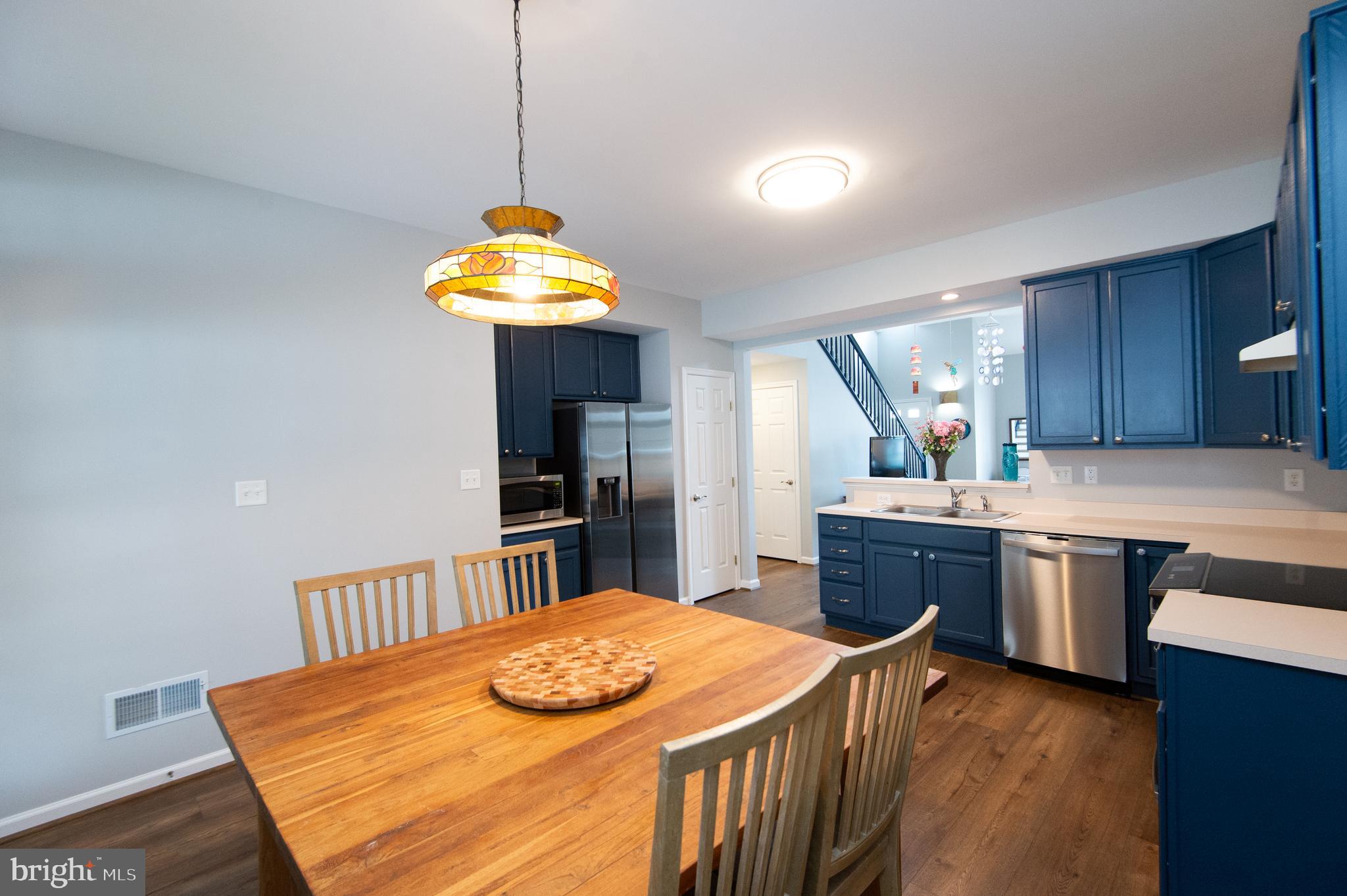 47 Brighton Street Ocean View, DE 19970 - Photo 7 of 44 a kitchen with kitchen island a sink a stove and a wooden floors