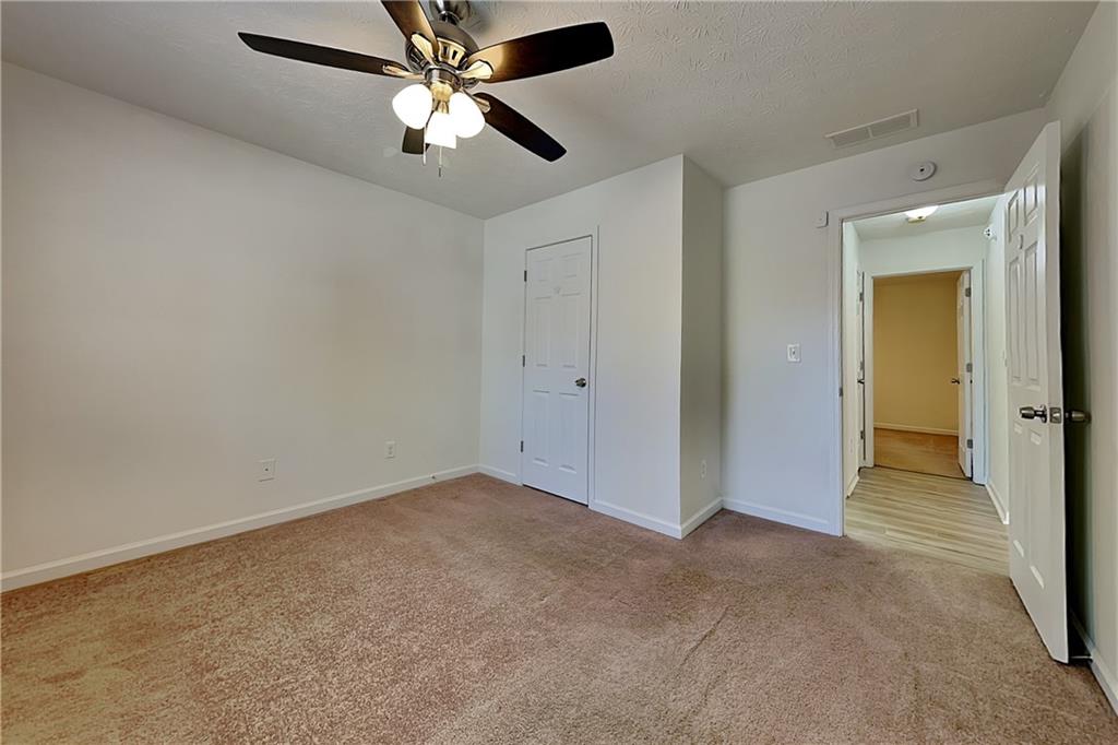 4206 Shoreside Circle Southwest Snellville, GA 30039 - Photo 11 of 20 an empty room and chandelier fan