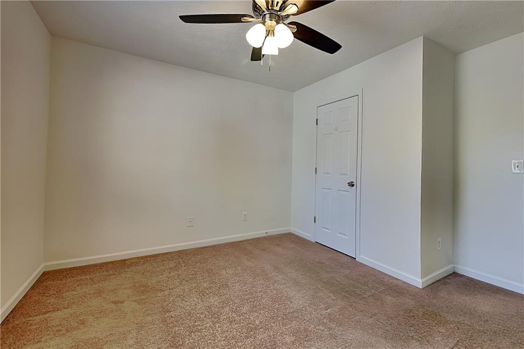 4206 Shoreside Circle Southwest Snellville, GA 30039 - Photo 12 of 20 an empty room with chandelier fan