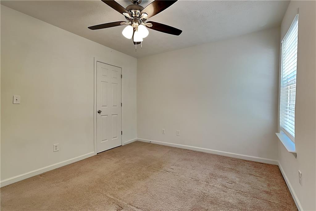 4206 Shoreside Circle Southwest Snellville, GA 30039 - Photo 14 of 20 an empty room with a window and a fan