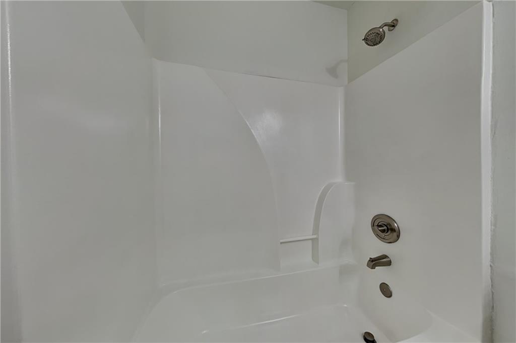 4206 Shoreside Circle Southwest Snellville, GA 30039 - Photo 17 of 20 a bathroom with a glass shower door