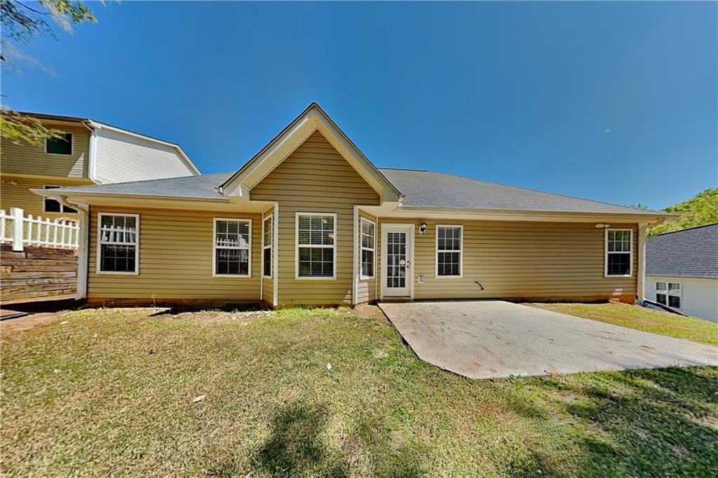 4206 Shoreside Circle Southwest Snellville, GA 30039 - Photo 18 of 20 a front view of house with yard outdoor seating and barbeque oven