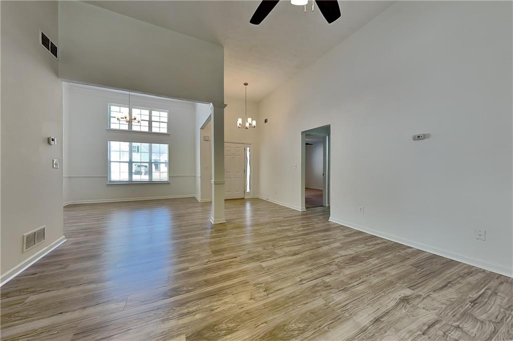 4206 Shoreside Circle Southwest Snellville, GA 30039 - Photo 2 of 20 an empty room with wooden floor and windows