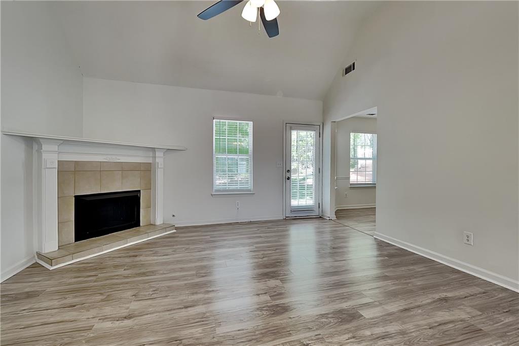4206 Shoreside Circle Southwest Snellville, GA 30039 - Photo 3 of 20 wooden floor fireplace and windows in an empty room