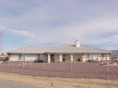 16155 Monache Road Apple Valley, CA 92307 - Photo 1 of 1 a front view of a house with a yard