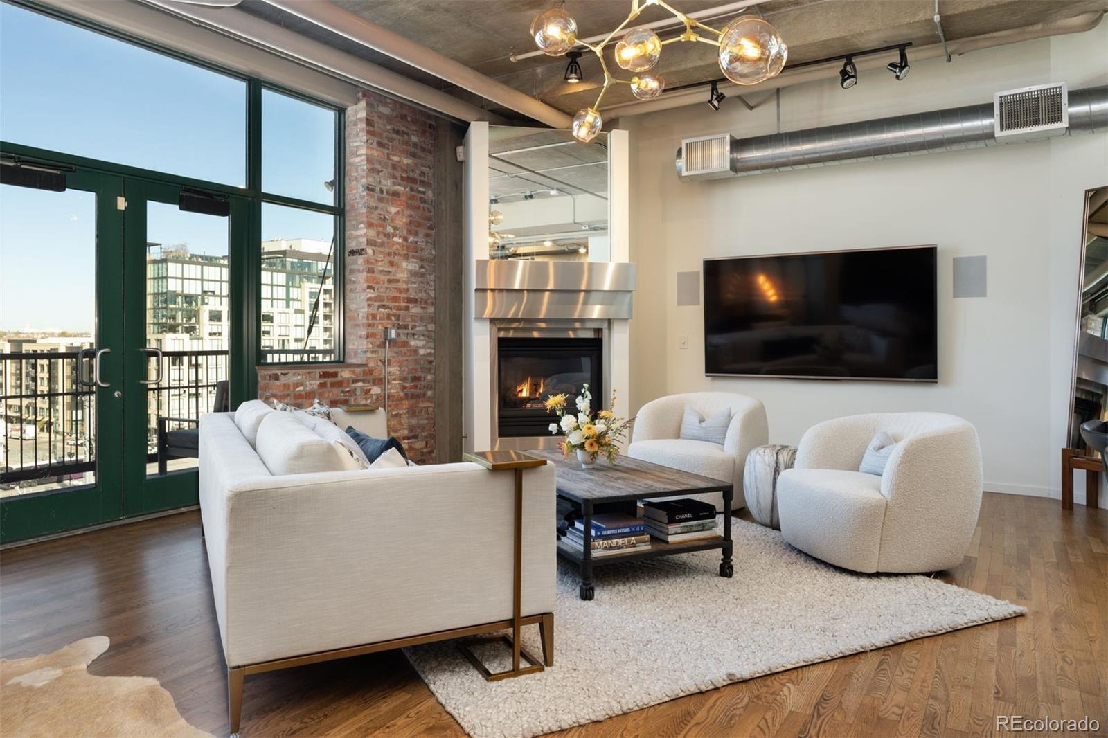 a living room with furniture a fireplace and a flat screen tv