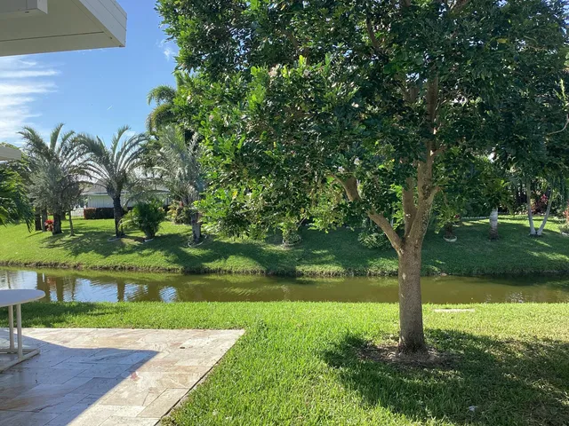 a kitchen with stainless steel appliances kitchen island granite countertop a stove and a sink