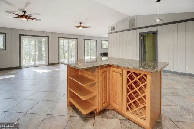 a view of a livingroom with furniture and a ceiling fan