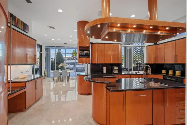 a kitchen with stainless steel appliances a sink stove and cabinets