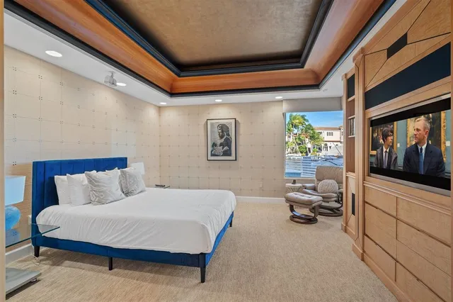 a bedroom with furniture and a flat screen tv