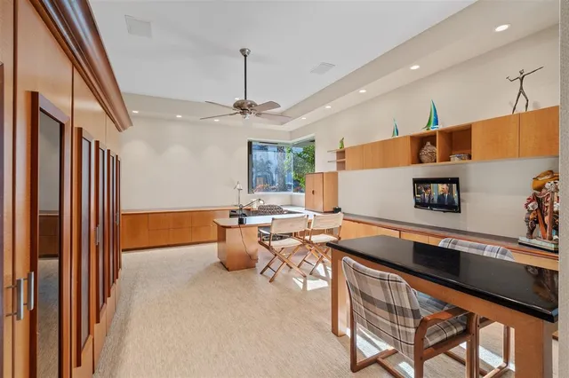 a living room with stainless steel appliances kitchen island granite countertop furniture and a sink