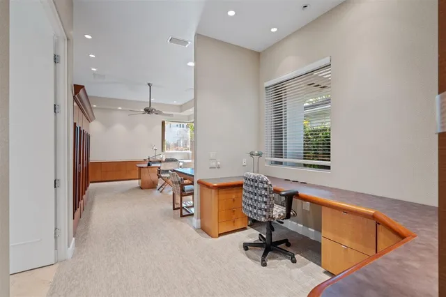 a view of a workspace with furniture and a window