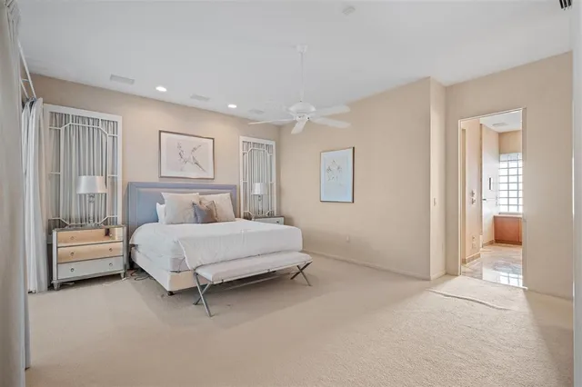 a spacious bedroom with a bed and a walk in closet