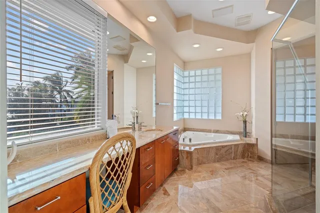 a spacious bathroom with a large tub and sink