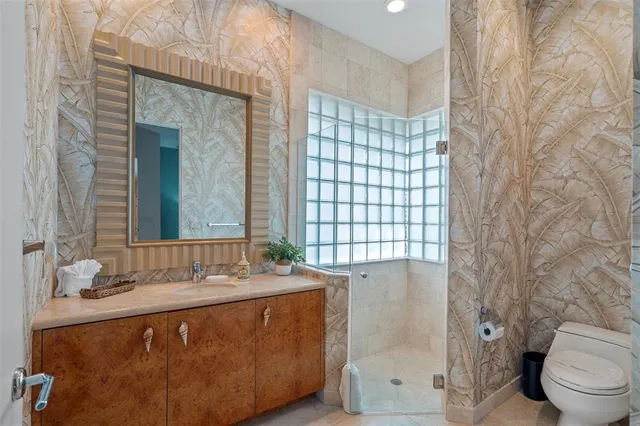 a bathroom with a sink toilet and shower