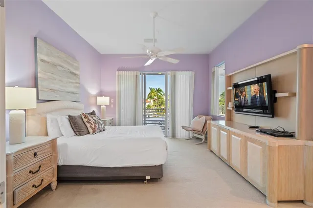 a bedroom with a large bed and a flat screen tv